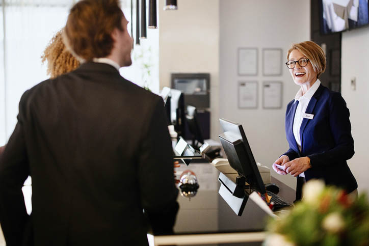 Two female hotel staff are talking and working together, whilst conducting an energy efficiency audit.